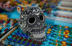 huichol bead-art skull on top of huichol bracelets